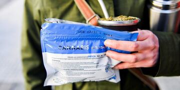 A woman holds her bag of legal marijuana and \