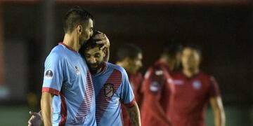 Argentina's Arsenal forward Juan Sanchez Sotelo (L) celebrates with teammate Lucas Wilchez after scoring his second goal against Peru's Juan Aurich during the Copa Sudamericana first round second leg football match at Arsenal stadium in Sarandi, Buenos Aires on May 11, 2017. / AFP PHOTO / JUAN MABROMATA