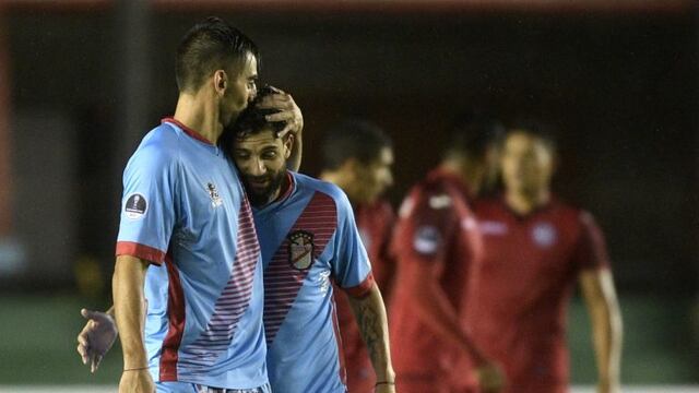 Argentina's Arsenal forward Juan Sanchez Sotelo (L) celebrates with teammate Lucas Wilchez after scoring his second goal against Peru's Juan Aurich during the Copa Sudamericana first round second leg football match at Arsenal stadium in Sarandi, Buenos Aires on May 11, 2017. / AFP PHOTO / JUAN MABROMATA
