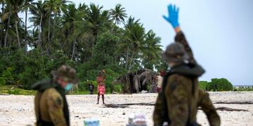 In this photo provided by the Australian Defence Force, an Australian Army helicopter lands on Pikelot Island in the Federated States of Micronesia where three men were found, Sunday, Aug\u002E 2, 2020, safe and healthy after missing for three days\u002E The men were missing in the Micronesia archipelago east of the Philippines for nearly three days when their \