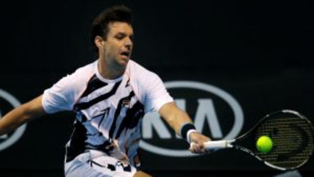 Argentina's Horacio Zeballos makes a forehand return to Croatia's Ivo Karlovic during their first round match at the Australian Open tennis championships in Melbourne, Australia, Tuesday, Jan. 17, 2017. (AP Photo/Aaron Favila)