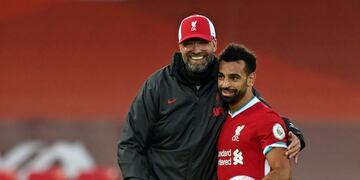 Liverpool's Egyptian midfielder Mohamed Salah (R) takes the match ball as he walks off with Liverpool's German manager Jurgen Klopp (L) after the English Premier League football match between Liverpool and Leeds United at Anfield in Liverpool, north west England on September 12, 2020\u002E - Liverpool won the game 4-3\u002E (Photo by Shaun Botterill / POOL / AFP) / RESTRICTED TO EDITORIAL USE\u002E No use with unauthorized audio, video, data, fixture lists, club/league logos or 'live' services\u002E Online in-match use limited to 120 images\u002E An additional 40 images may be used in extra time\u002E No video emulation\u002E Social media in-match use limited to 120 images\u002E An additional 40 images may be used in extra time\u002E No use in betting publications, games or single club/league/player publications\u002E /