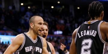 San Antonio Spurs guard Manu Ginobili (20) and center Pau Gasol, center, celebrate with teammate Kawhi Leonard (2) after a basket with 5.8 second left by Leonard in the fourth quarter of an NBA basketball game in Oklahoma City, Friday, March 31, 2017. Leo