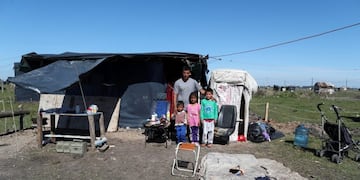 Sergio Ponce, 25, poses for a picture with his family at the patch of land he occupied, amid the spread of the coronavirus disease (COVID-19) in Guernica, on the outskirts of Buenos Aires, Argentina September 16, 2020\u002E REUTERS/Agustin Marcarian