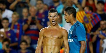 Soccer Football - Barcelona v Real Madrid Spanish Super Cup First Leg - Barcelona, Spain - August 13, 2017 Real Madrid’s Cristiano Ronaldo celebrates scoring their second goal with Raphael Varane and is later booked for removing his shirt REUTERS/Juan Medina TPX IMAGES OF THE DAY