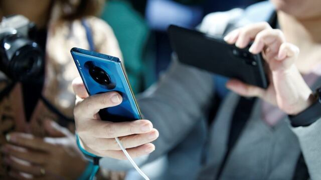 Attendees inspect a Huawei Technologies Co\u002E Mate 30 smartphone during the device's unveiling in Munich, Germany, on Thursday, Sept\u002E 19, 2019\u002E The Huawei Mate 30 and Mate 30 Pro mark the brand’s first top-of-the-range device launch since it was forbidden in the spring from trading with American partners\u002E Photographer: Michaela Handrek-Rehle/Bloomberg