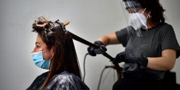 Andrea, 29 years old, is attended by hairstylist Laura Naturana in a hairdresser, Pamplona, northern Spain, Monday, May 4, 2020\u002E Spaniards will be able to get a haircut, buy take away food as long as they have previously made an appointment and travel on public transport with mouth and nose covered with mandatory masks\u002E (AP Photo/Alvaro Barrientos)