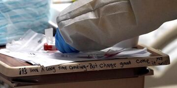 Medical student Engerlina Olivares handles a COVID-19 test from a patient inside the Coronavirus Unit at United Memorial Medical Center, Monday, July 6, 2020, in Houston\u002E Texas is seeing a surge in the number of people testing positive for the coronavirus since it loosened restrictions on gatherings in May\u002E (AP Photo/David J\u002E Phillip)