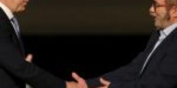 Colombia's President Juan Manuel Santos, left, shakes hands with Rodrigo Londono, known as Timochenko, top leader of the Revolutionary Armed Forces of Colombia, FARC, after signing a revised peace agreement at Colon Theater in Bogota, Colombia, Thursday, Nov. 24, 2016. An original accord ending the half century conflict was rejected by voters in a referendum last month. (AP Photo/Fernando Vergara)