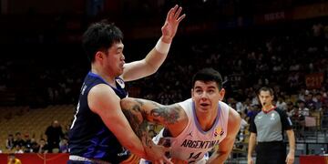 Gabriel Deck of Argentina, right, is tackled by Lee Seounghyun of South Korea during their group phase basketball game in the FIBA Basketball World Cup, at the Sport Center in Wuhan in central China's Hubei province, Saturday, Aug\u002E 31, 2019\u002E (AP Photo/Andy Wong)