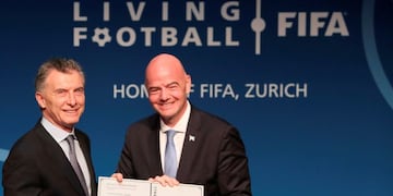 Handout picture released by Argentina's Presidency showing Argentinian President Mauricio Macri (L) receiving the FIFA Living Football award from FIFA President Gianni Infantino in Zurich on June 30, 2019\u002E (Photo by Juan MABROMATA / Argentinian Presidency / AFP) / RESTRICTED TO EDITORIAL USE - MANDATORY CREDIT \