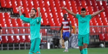 Soccer Football - La Liga Santander - Granada v Real Madrid - Nuevo Estadio de Los Carmenes, Granada, Spain - July 13, 2020 Real Madrid's Sergio Ramos and Casemiro celebrate after the match, as play resumes behind closed doors following the outbreak of the coronavirus disease (COVID-19) REUTERS/Jon Nazca