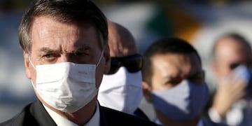 Brazil's President Jair Bolsonaro arrives for a flag raising ceremony outside Alvorada palace, the presidential residence in Brasilia, Brazil, Tuesday, May 12, 2020\u002E The morning ceremony flew Brazil's flag at half mast to mourn those who have died from the new coronavirus\u002E (AP Photo/Eraldo Peres)