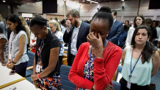 A handout photo by UNEP shows the UN Staff observing a minute of silence for the victims of the accident of the Ethiopian Airlines, including 19 UN workers, before the opening plenary of the 4th UN Environment Assembly at the UN headquaters in Nairobi, Kenya, on March 11, 2019\u002E (Photo by UNEP/C\u002E Villemain / UNEP / AFP)