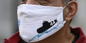 A man wears a handmade face mask with the silhouete of the ARA San Juan submarine in Buenos Aires, Argentina, on August 6, 2020, amid the COVID-19 pandemic\u002E - On November 2017 the ARA San Juan submarine sunk at 907 meters (2,975 feet) of depth, some 500 km from the southern city of Comodoro Rivadavia taking the lives of 44 crew\u002E (Photo by JUAN MABROMATA / AFP)