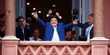 Former soccer great Diego Maradona flashes victory signs to fans below at the Casa Rosada government house after meeting with Argentine President Alberto Fernandez in Buenos Aires, Argentina, Thursday, Dec\u002E 26, 2019\u002E Decades ago, Maradona held up his team's soccer trophy at this spot on the balcony after winning the World Cup in Mexico in 1986\u002E (AP Photo/Marcos Brindicci)