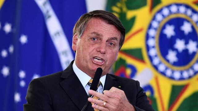 Brazilian President Jair Bolsonaro gestures as he speaks during the launch of a program for the resumption of tourism, a sector severely affected by the new coronavirus outbreak, at Planalto Palace in Brasilia, on November 10, 2020\u002E - Brazil's decision to halt trials of a Chinese-developed Covid-19 vaccine triggered a politically charged row Tuesday as a top health official expressed \