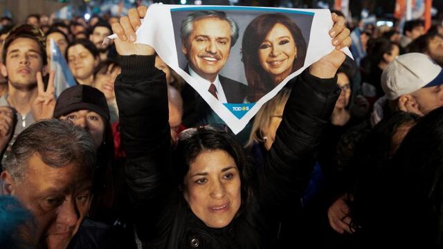 A supporter of presidential candidate Alberto Fernandez holds up a handkerchief with photos of him and his running-mate, former President Cristina Fernandez, outside the \