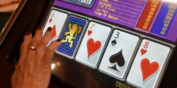 A player swipes the screen on a video poker machine at the Monte Bar and Casino in Billings, Montana, Tuesday, April 23, 2019\u002E Almost a year after the U\u002ES\u002E Supreme Court ended Nevada's monopoly on sports betting, Montana, Iowa and Indiana are poised to legalize sports betting\u002E (AP Photo/Matthew Brown)