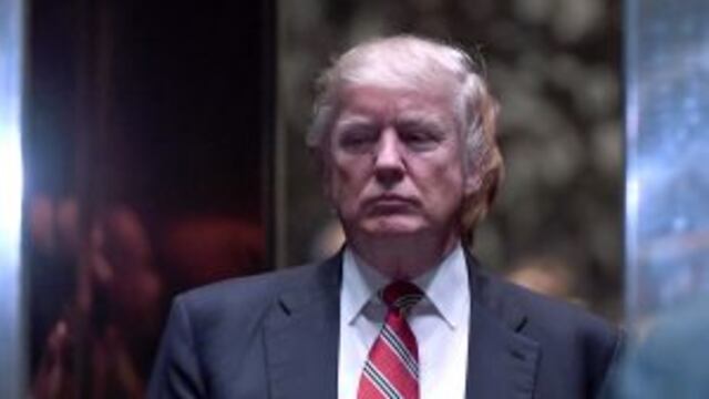 U.S. President-elect Donald Trump, center, waits in an elevator in the lobby of Trump Tower in New York, U.S., on Monday, Jan. 16, 2017. President-elect Donald Trump's pledge to cancel the executive orders of his predecessor would have wide-ranging implic