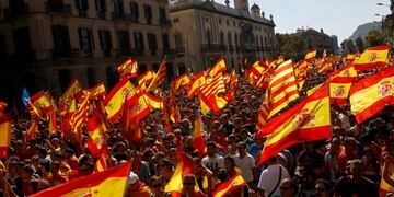 People wave Spanish and Catalan flags during a march in downtown Barcelona, Spain, to protest the Catalan government's push for secession from the rest of Spain, Sunday Oct\u002E 8, 2017\u002E Sunday's rally comes a week after separatist leaders of the Catalan government held a referendum on secession that Spain's top court had suspended and the Spanish government said was illegal\u002E (AP Photo/Francisco Seco)