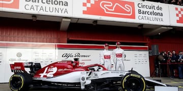 Drivers Kimi Raikkonen of Finland, left, and Antonio Giovinazzi of Italy, right, pose for photos with the new Alfa Romeo F1 car during a presentation of the new livery at the Barcelona Catalunya racetrack in Montmelo, outside Barcelona, Spain, Monday, Feb\u002E18, 2019\u002E (AP Photo/Manu Fernandez)