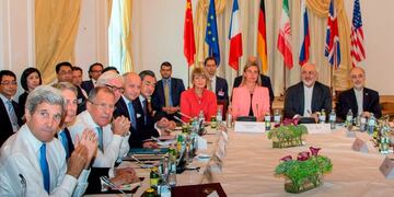 (FILES) This file photo taken on July 6, 2015 shows (L-R) then US Secretary of State John Kerry, then British Foreign Minister Philip Hammond, Russian Foreign Minister Sergey Lavrov, then German Foreign Minister Frank-Walter Steinmeier, then French Foreign Minister Laurent Fabius, China's Foreign Minister Wang Yi, EU Secretary General for the External Action Service Helga Schmid, then High Representative of the European Union for Foreign Affairs and Security Policy Federica Mogherini, Iranian Foreign Minister Mohammad Javad Zarif and Iran's ambassador to IAEA, Ali Akbar Salehi, as they meet at Palais Coburg Hotel, where the Iran nuclear talks meetings were being held, in Vienna, Austria\u002E - The 2015 nuclear deal between Iran and world powers has been left in tatters after Tehran on January 5 2020 announced a further rollback of its commitments under the landmark accord following the US assassination of Iranian top general Qasem Soleimani\u002E (Photo by Joe KLAMAR / AFP)