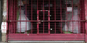 A shutter of a closed shop with a notice that reads \