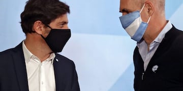 The Head of Government of the Autonomous City of Buenos Aires, Horacio Rodriguez Larreta (R) and Buenos Aires Province Governor Axel Kicillof, both wearing face masks, leave after attending a press conference with Argentine President Alberto Fernandez (out of frame) to announce new measures regarding the lockdown to slow the spread of the novel coronavirus COVID-19, at Olivos Residence in Olivos, north of Buenos Aires, on May 23, 2020\u002E - The pandemic has killed at least 338,128 people worldwide since it surfaced in China late last year, according to an AFP tally at 1100 GMT on Saturday based on official sources\u002E (Photo by Alejandro PAGNI / AFP)
