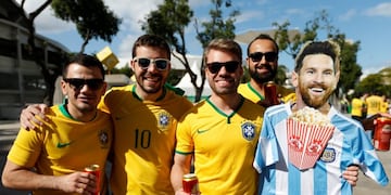 Fans of Brazil hold a life-size cardboard cut-out of Argentina's striker Lionel Messi eating popcorn and wearing an Argentina soccer jersey outside the Maracana stadium prior to the final soccer match of the Copa America between Brazil and Peru in Rio de Janeiro, Brazil, Sunday, July 7, 2019\u002E (AP Photo/Natacha Pisarenko)