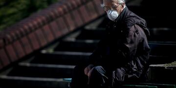 AME6714\u002E BUENOS AIRES (ARGENTINA), 22/09/2020\u002E- Un hombre sin hogar permanece sentado mientras usa tapabocas hoy en la ciudad de Buenos Aires (Argentina)\u002E Desde que el 3 de marzo se registró su primer caso, en Argentina se han detectado con COVID-19 un total de 640\u002E147 personas -de las que 508\u002E563 ya se han recuperado y 13\u002E482 han muerto-, lo que la ubica en décimo lugar del mundo por número de afectados y decimocuarto por fallecidos, según el recuento independiente de la Universidad Johns Hopkins\u002E EFE/Juan Ignacio Roncoroni
