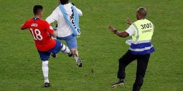 CAF17110\u002E RÍO DE JANEIRO (BRASIL), 25/06/2019\u002E- Gonzalo Jara (i) de Chile traba a un aficionado que invadió el campo, durante el partido Chile-Uruguay del Grupo C de la Copa América de Fútbol 2019, en el Estadio Maracanã de Río de Janeiro, Brasil, hoy 24 de junio de 2019\u002E EFE/Julio César Guimarães