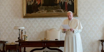 A photo taken and handout on March 25, 2020 by the Vatican Media shows Pope Francis reciting the \