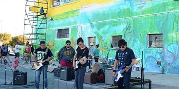 Artistas realizan un mural en el Complejo Deportivo Municipal