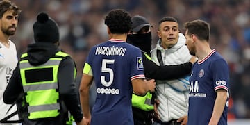 Un hincha del Marseille entra al campo de juego para abrazar a Messi del PSG durante el partido. (AP Photo/Daniel Cole)