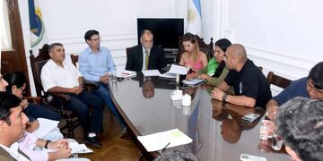 Los ministros Normando Álvarez García y Federico Cardozo, en la cabecera de la mesa, acompañados por funcionarios de sus equipos de trabajo, reunidos con dirigentes locales de los gremios ATSA, SOEMFA, ATE y UPCN.