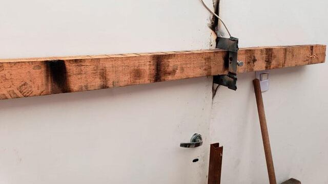 Tras el destrozo de la puerta del local, el dueño recurre a una tranca de madera para que no le sigan robando.