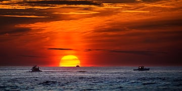 Sol saliendo por encima del mar, cambio climático.