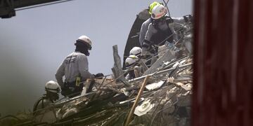 Bomberos y rescatistas trabajan entre los escombros del edificio que colapsó el pasado jueves 24 de junio por la madrugada en Surfside, Miami.