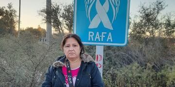 La mamá de Rafael Arnaldo Morales Miranda junto al cartel con un ángel azul que lo recuerda.