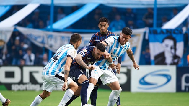 Nahuel Bustos, rodeado, en el partido que Talleres afrontó en Tucumán ante Atlético. (Prensa Talleres)