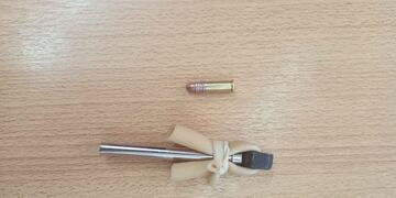 La tumbera y la bala encontrada en la Escuela "Mario R. Vecchioli"