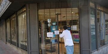 La mayoría de los comercios mendocinos no abrieron sus puertas, otros trabajan atendiendo bajo la modalidad "pase y lleve". Orlando Pelichotti /Los Andes