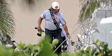Personal de bomberos trabaja buscando gente entre los escombros del edificio que colapsó en Miami.